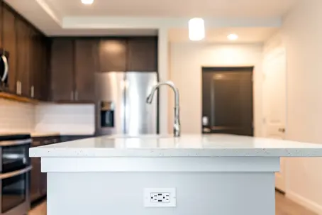 a kitchen island with an outlet on the side