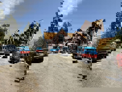 A large, rustic house in a wooded area