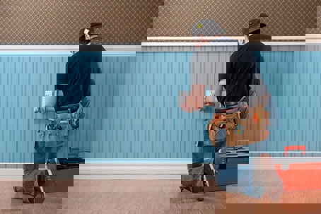 man installing an electrical outlet