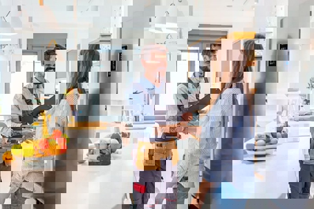 smiling technician shakes hands with a woman