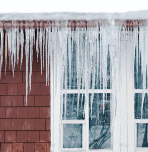 Long icicles hang from a snow-covered roof