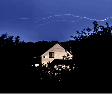 home stands strong among dark trees.